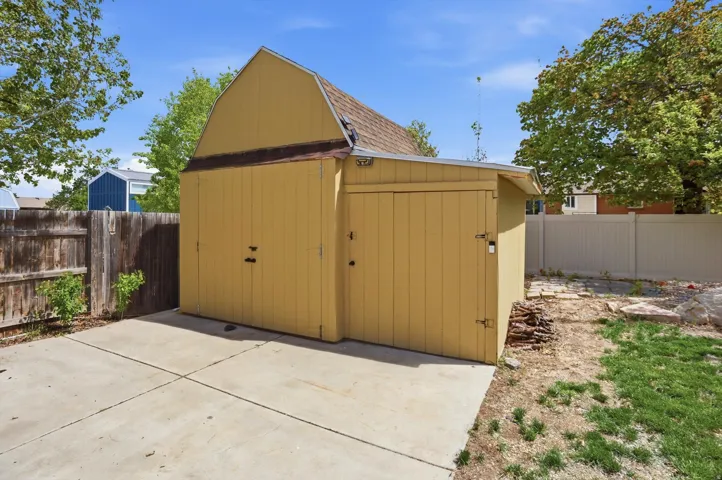 View of shed with a fenced backyard