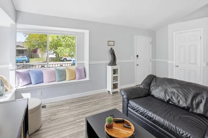 Living area featuring light wood-style flooring and baseboards