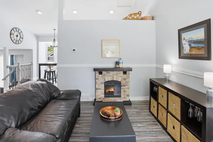 Living room featuring a fireplace, wood finished floors, and recessed lighting