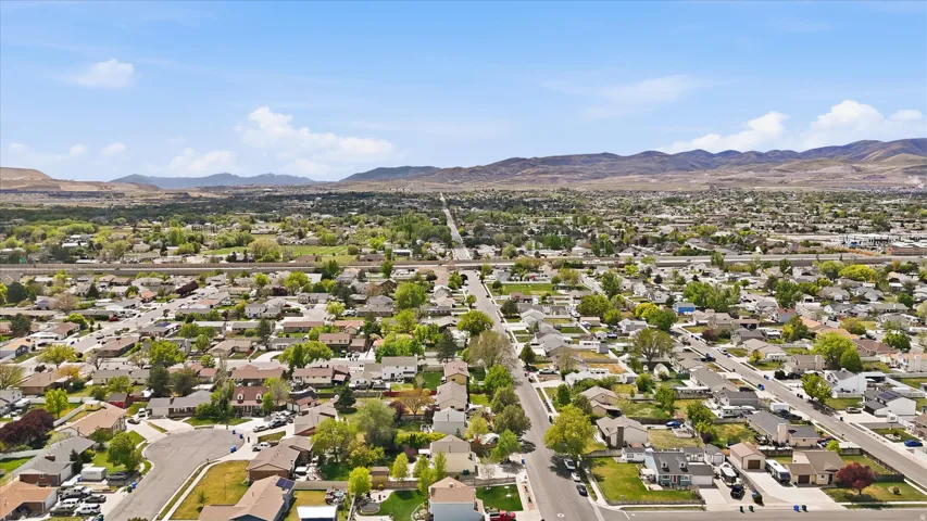 Aerial perspective of suburban area featuring a mountainous background