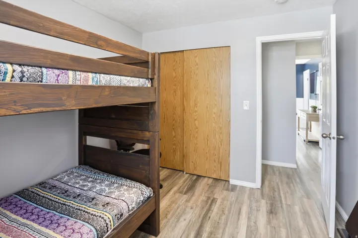 Bedroom featuring light wood-type flooring and a textured ceiling