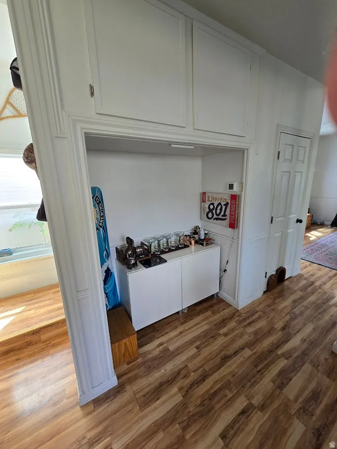 Laundry area with light wood-type flooring