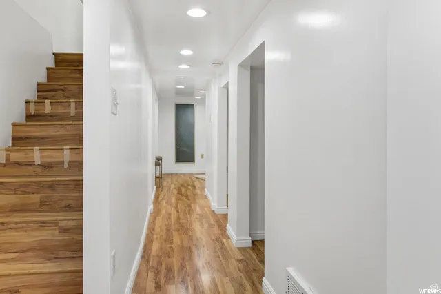 Hall with recessed lighting and light wood finished floors