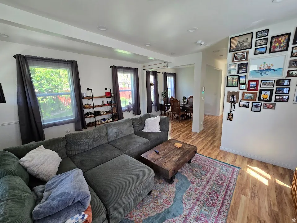 Living area featuring light wood-style floors and baseboards