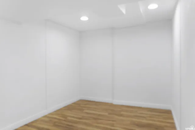 Empty room featuring wood finished floors and recessed lighting