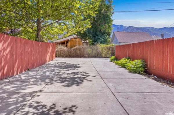Fenced backyard with a mountain view