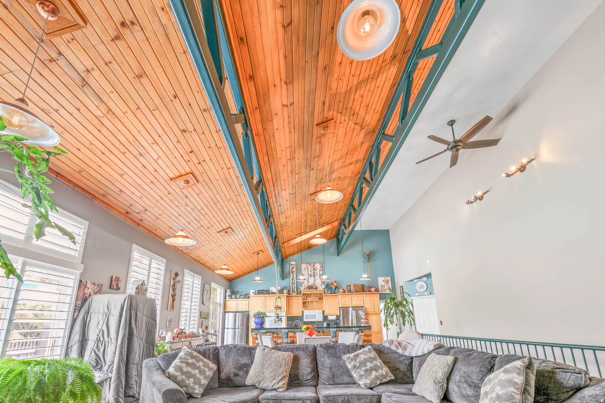 Living area featuring a vaulted wooden ceiling and ceiling fan