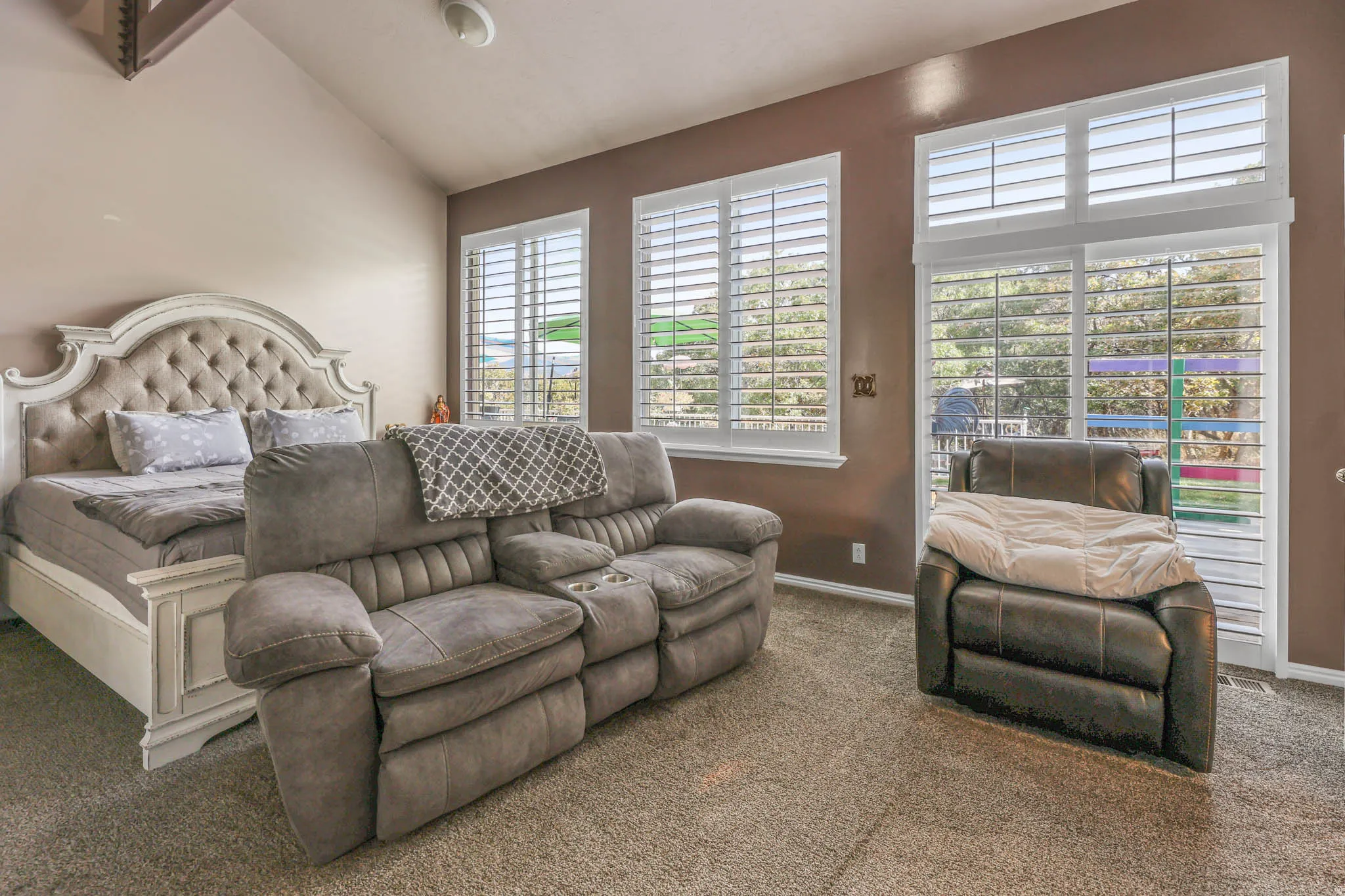 Bedroom featuring carpet flooring and vaulted ceiling