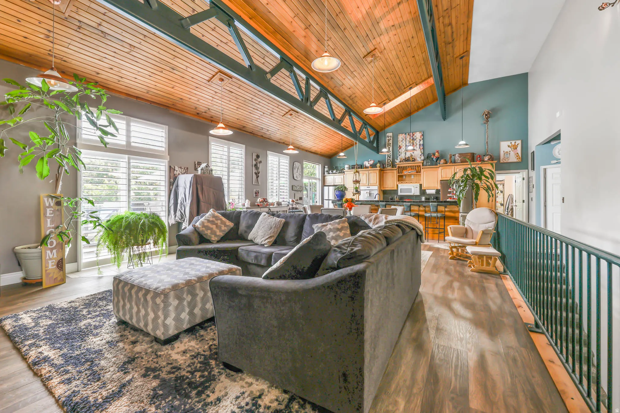Living area featuring a skylight, a high wooden beamed ceiling, and wood finished floors