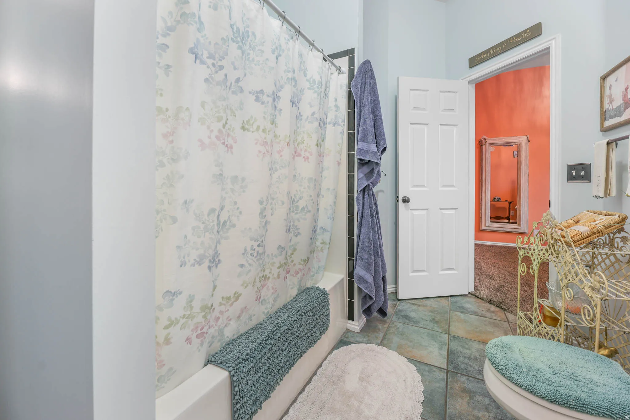 Full bathroom featuring shower / bathtub combination with curtain and tile patterned flooring