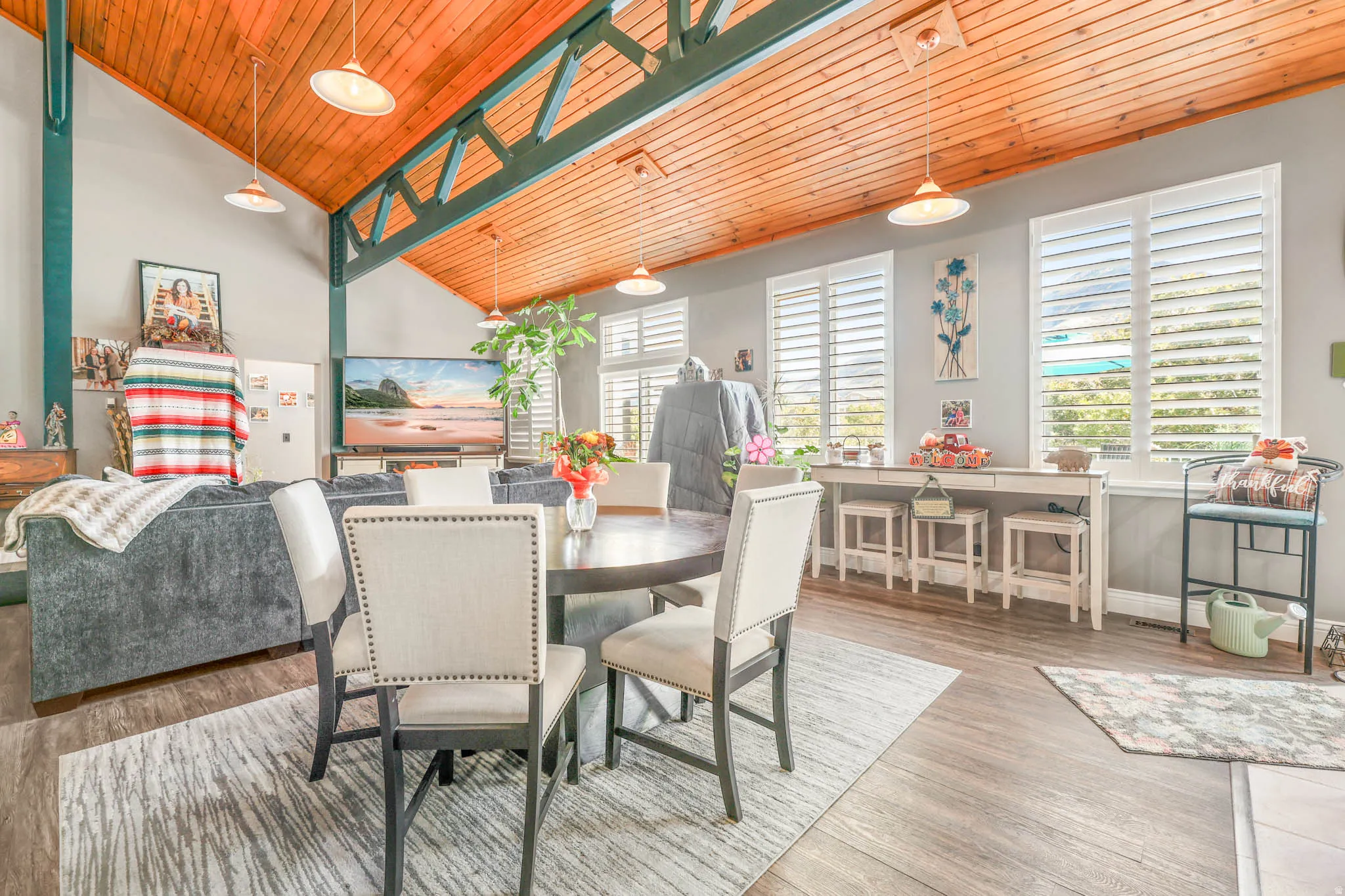 Dining space with wood finished floors, a vaulted wood ceiling, and plenty of natural light