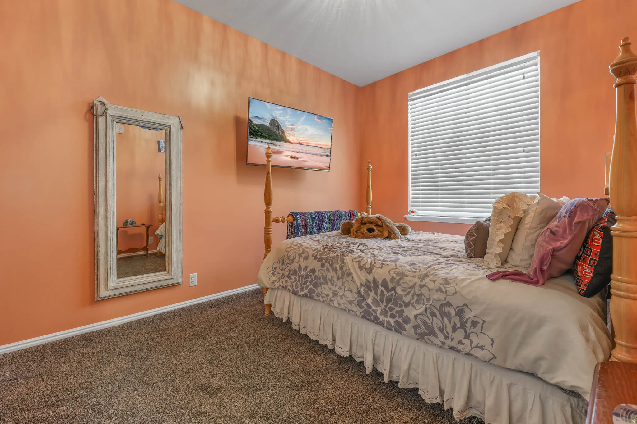 Bedroom featuring dark colored carpet and baseboards
