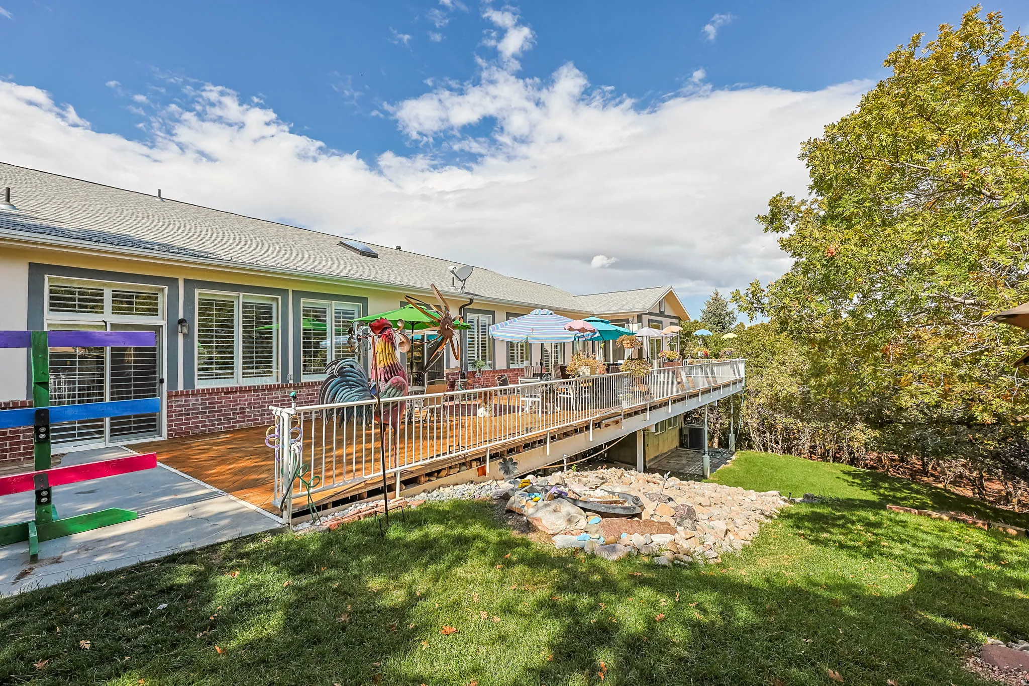 Wooden terrace featuring a lawn