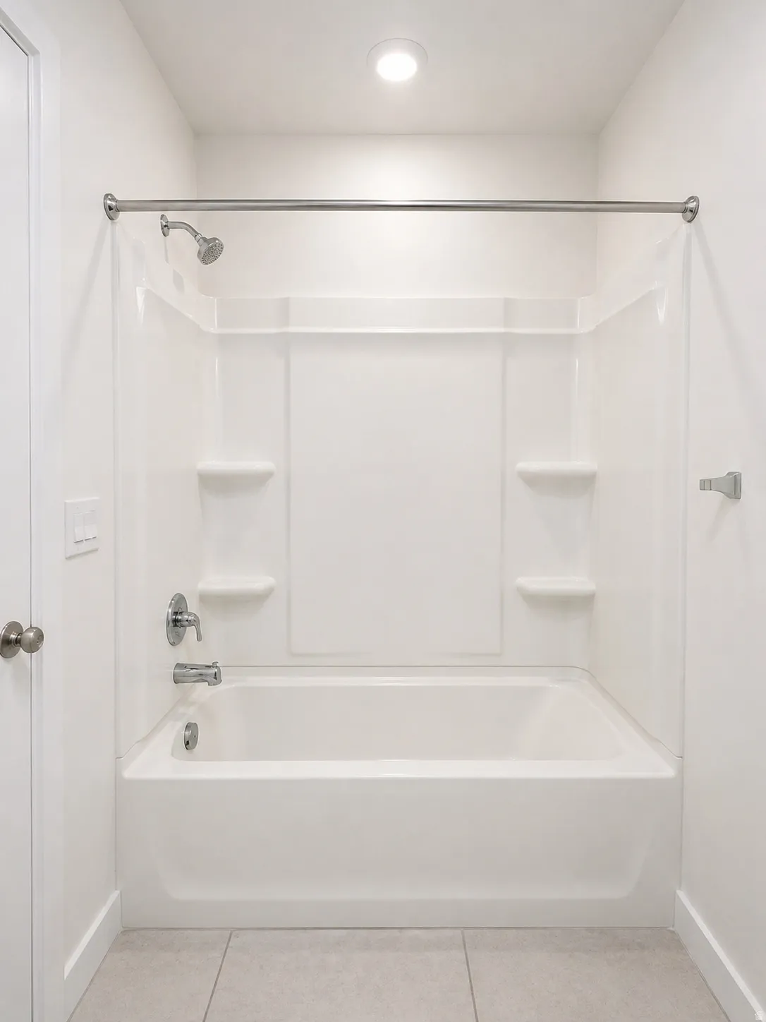 Full bathroom featuring light tile patterned floors and shower / bath combination