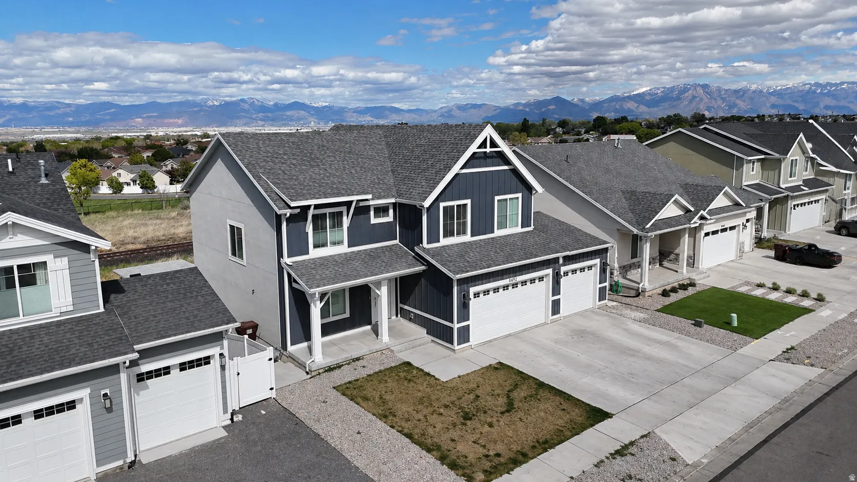 Craftsman-style house featuring a shingled roof, driveway, and a residential view
