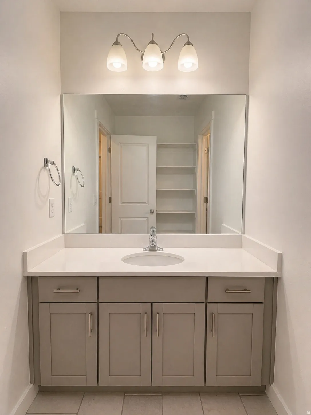 Bathroom featuring vanity and light tile patterned floors
