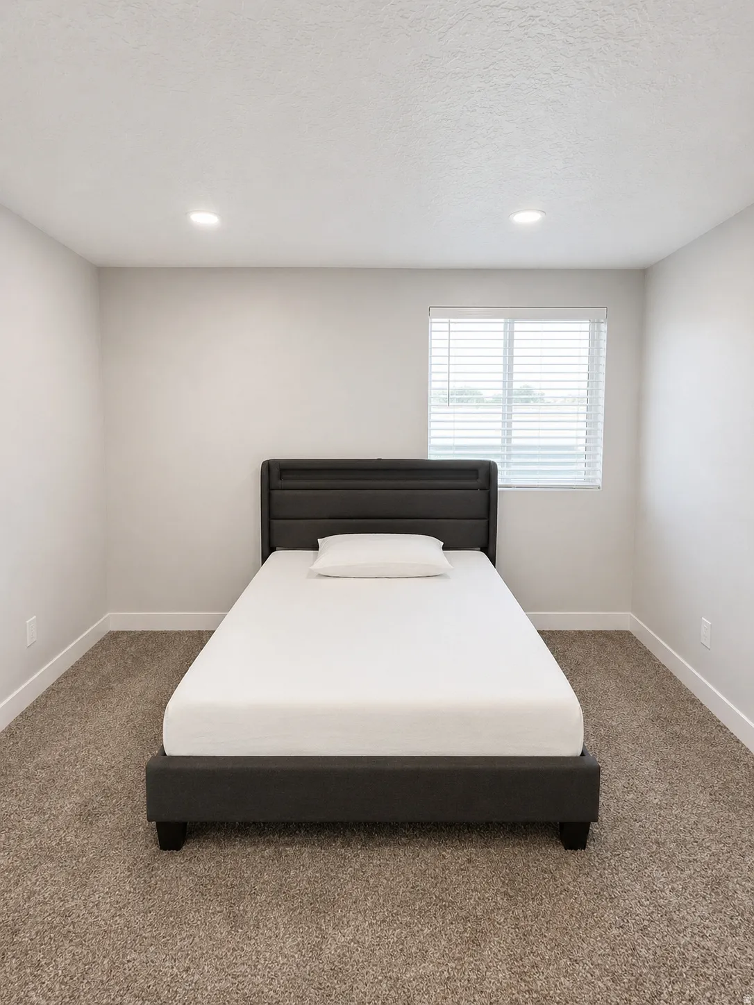 Bedroom featuring carpet floors, recessed lighting, and a textured ceiling