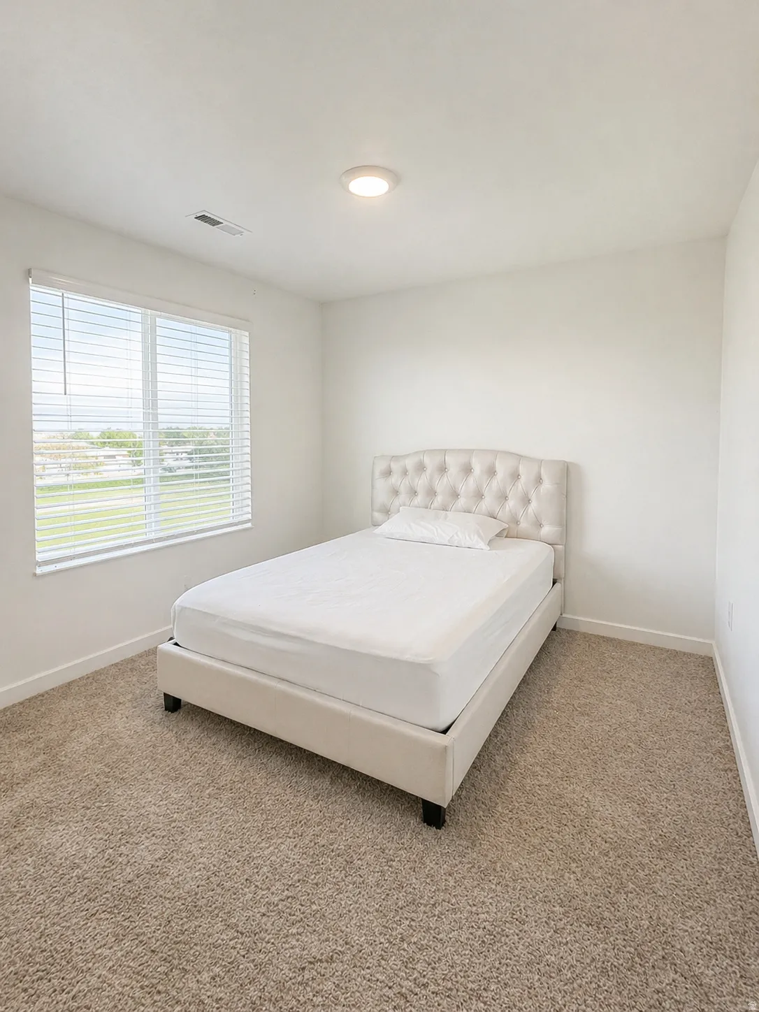 Bedroom with light carpet and recessed lighting