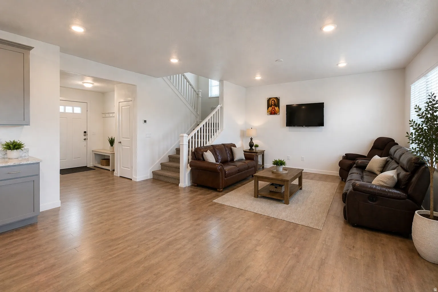 Living room with dark wood finished floors and recessed lighting