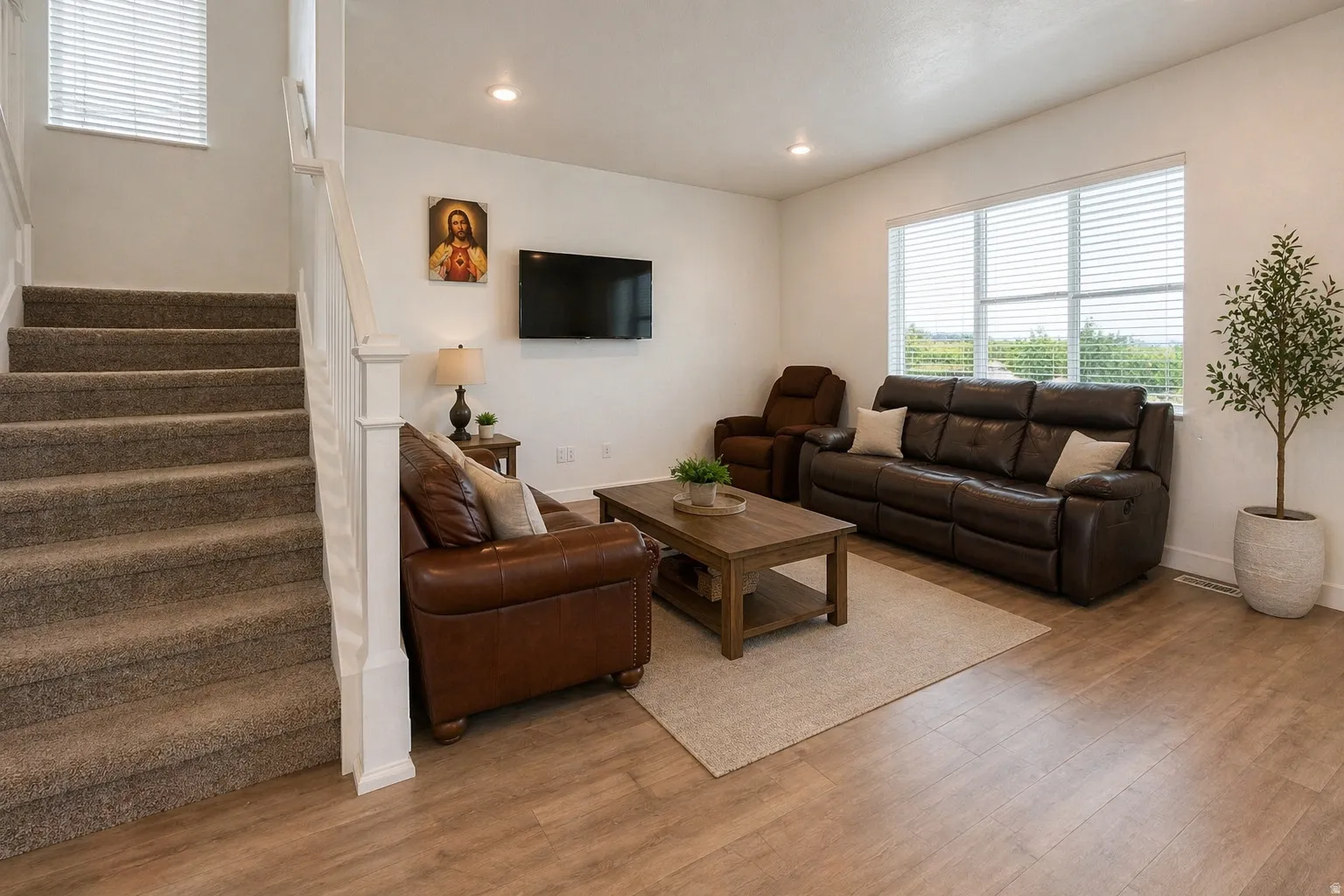 Living area featuring wood finished floors and recessed lighting