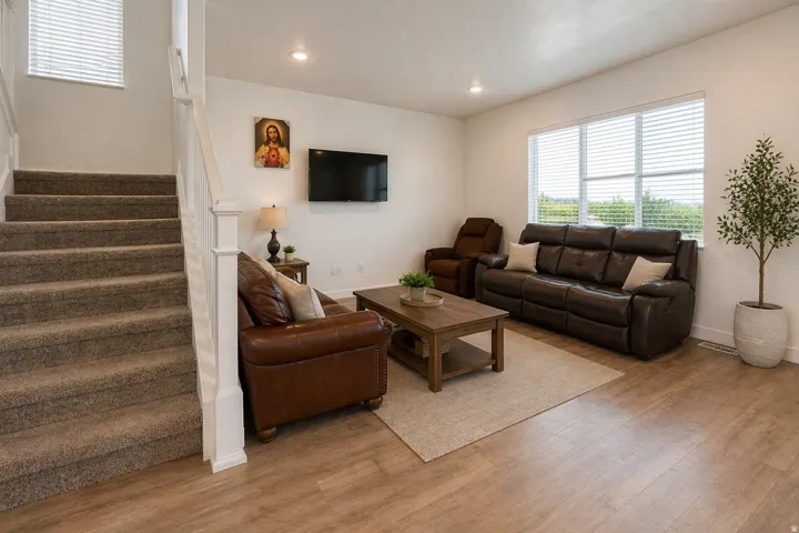 Living area featuring wood finished floors and recessed lighting