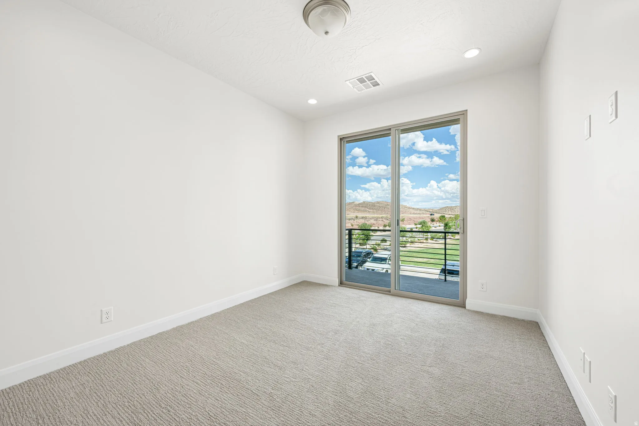 Expansive sliding glass doors provide broad natural light and mountain scenery