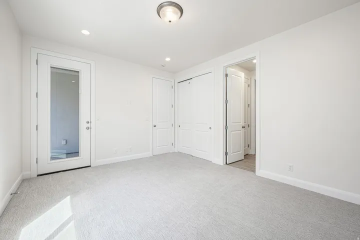 Carpeted room with recessed lighting and a flush mount ceiling fixture