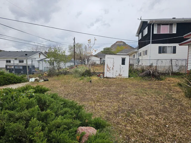 Fenced backyard with a shed