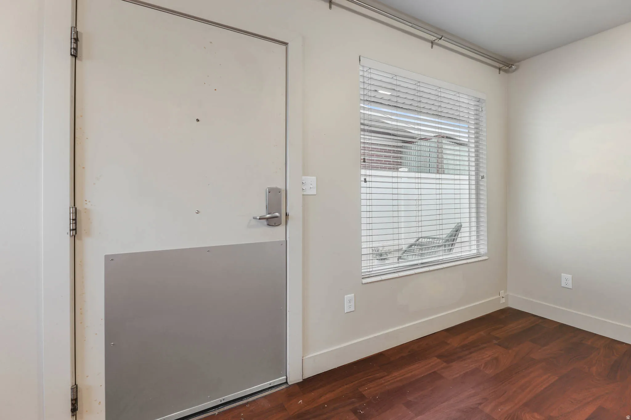 UNIT #1 Doorway featuring wood finished floors and baseboards