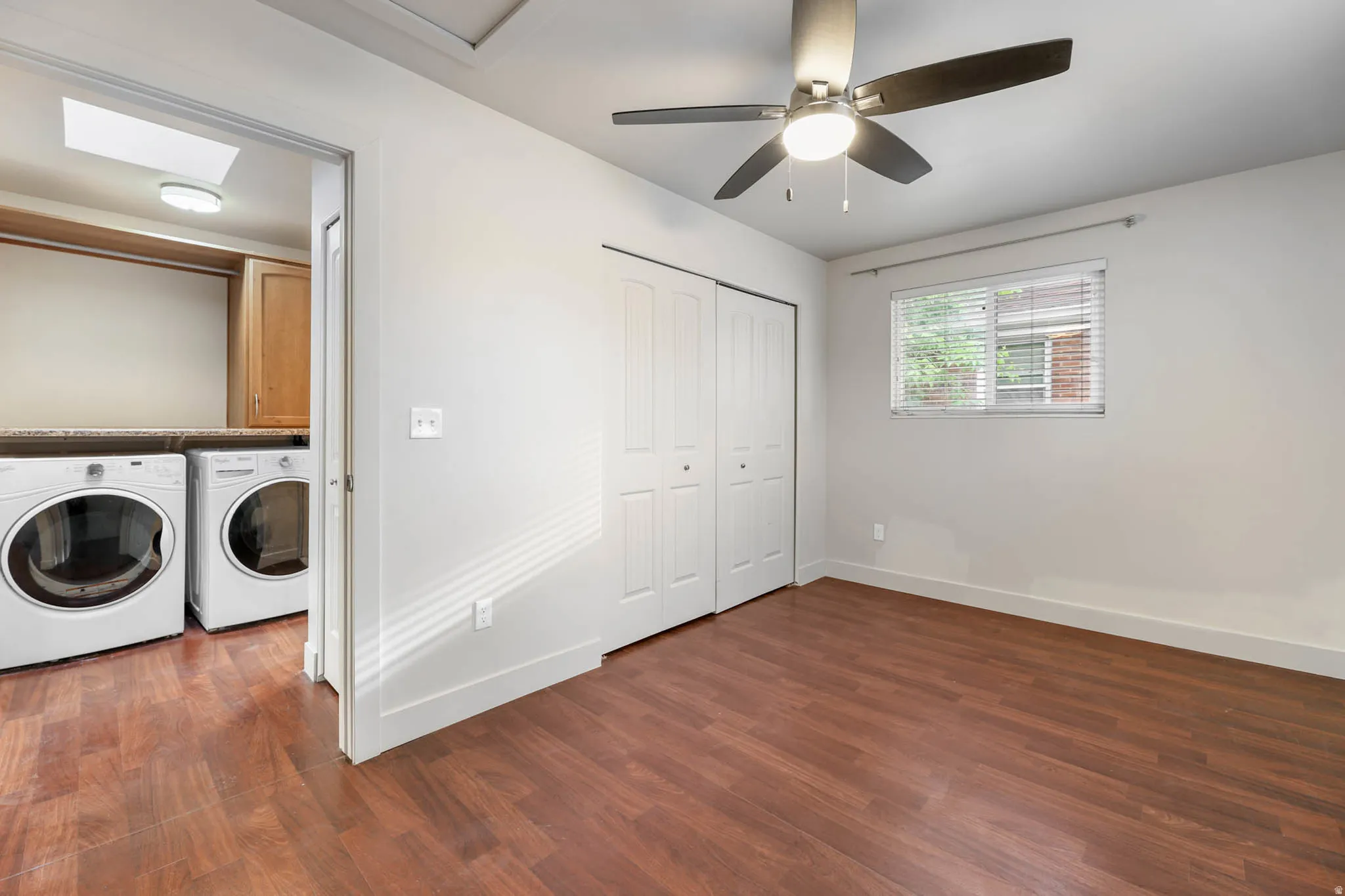 UNIT #1 Laundry room featuring dark wood-style flooring, independent washer and dryer, and ceiling fan