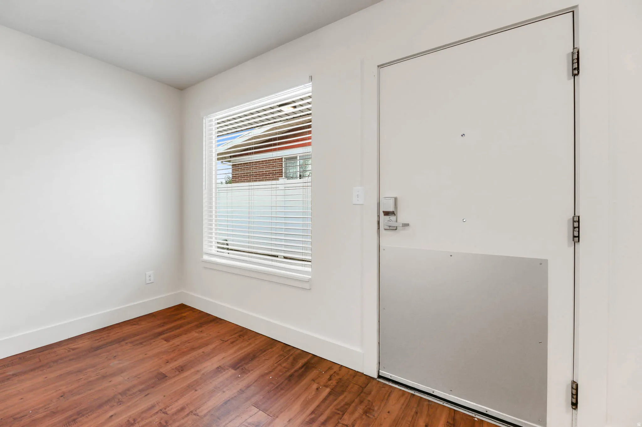 UNIT #2 Entryway featuring baseboards and wood finished floors