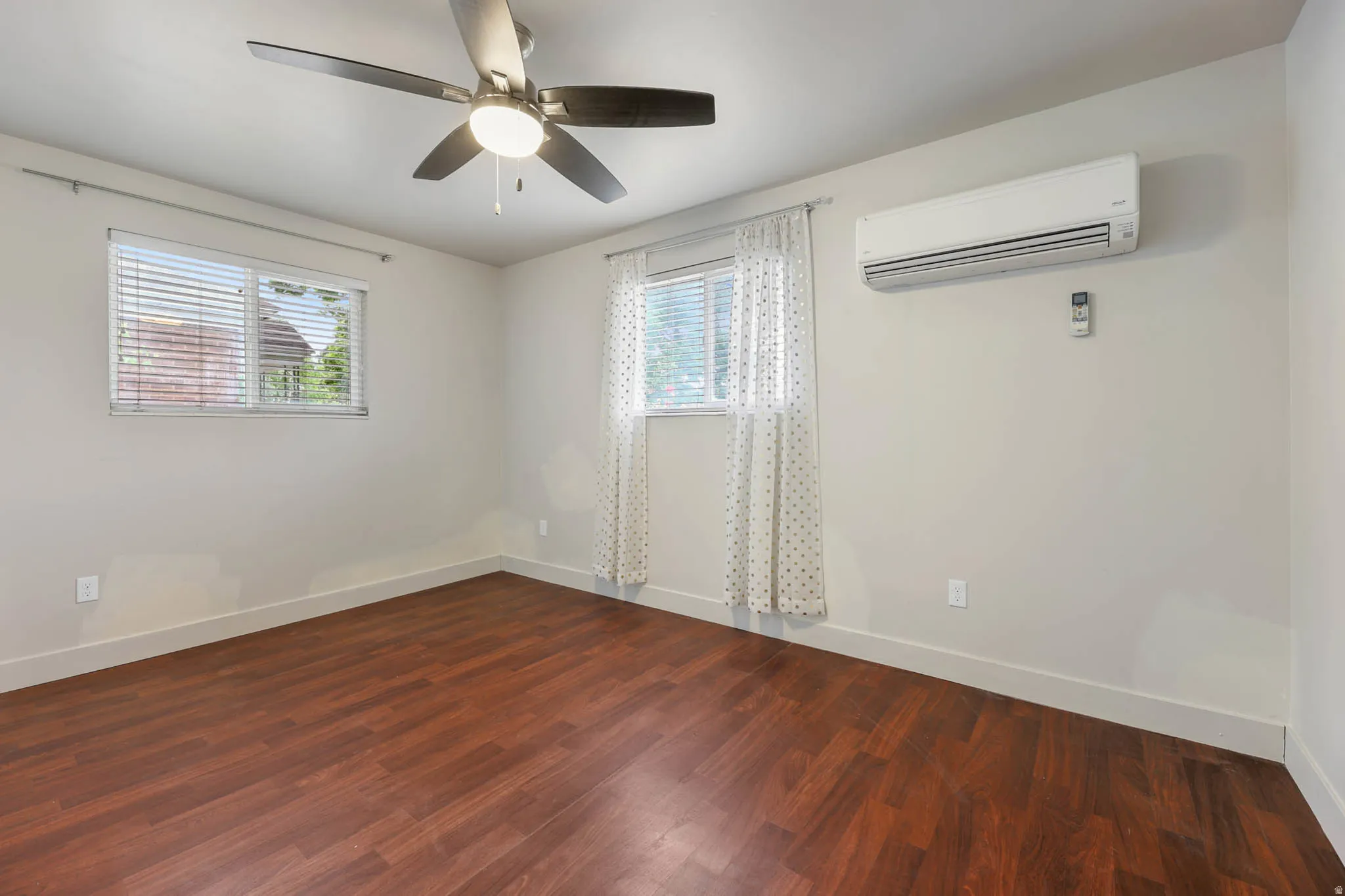 UNIT #1 Spare room with dark wood-style flooring and ceiling fan