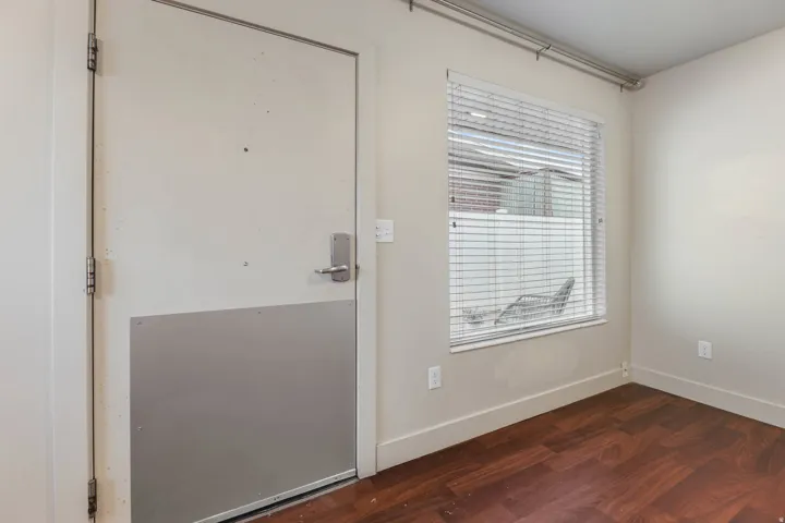 UNIT #1 Doorway featuring wood finished floors and baseboards