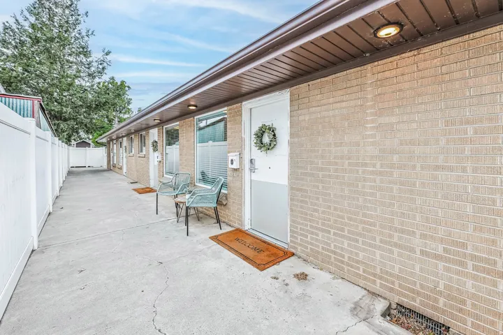 Entrance to property featuring brick siding and a gate