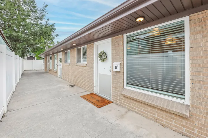 View of exterior entry with brick siding