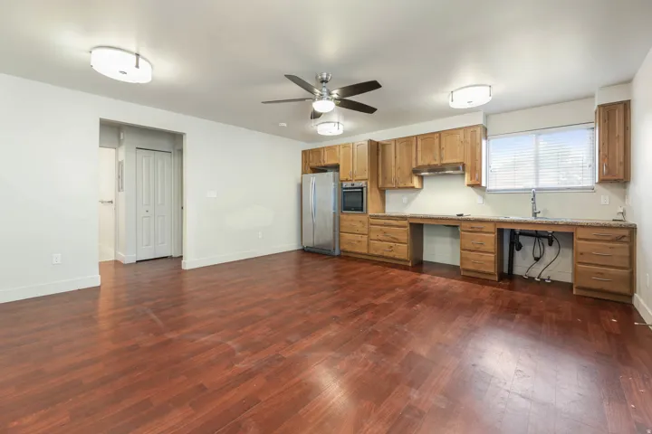 UNIT #1 Kitchen featuring light countertops, stainless steel appliances, dark wood-type flooring, and a ceiling fan