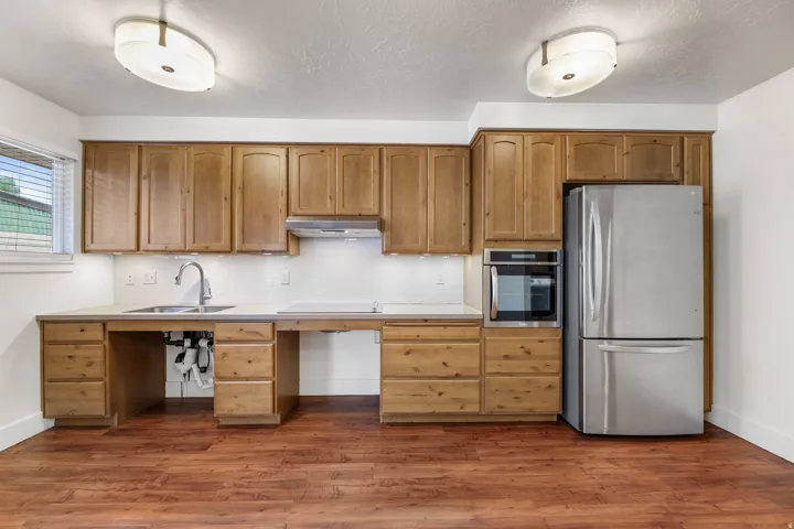 UNIT #2 Kitchen featuring stainless steel appliances, light countertops, dark wood-type flooring, tasteful backsplash, and a textured ceiling