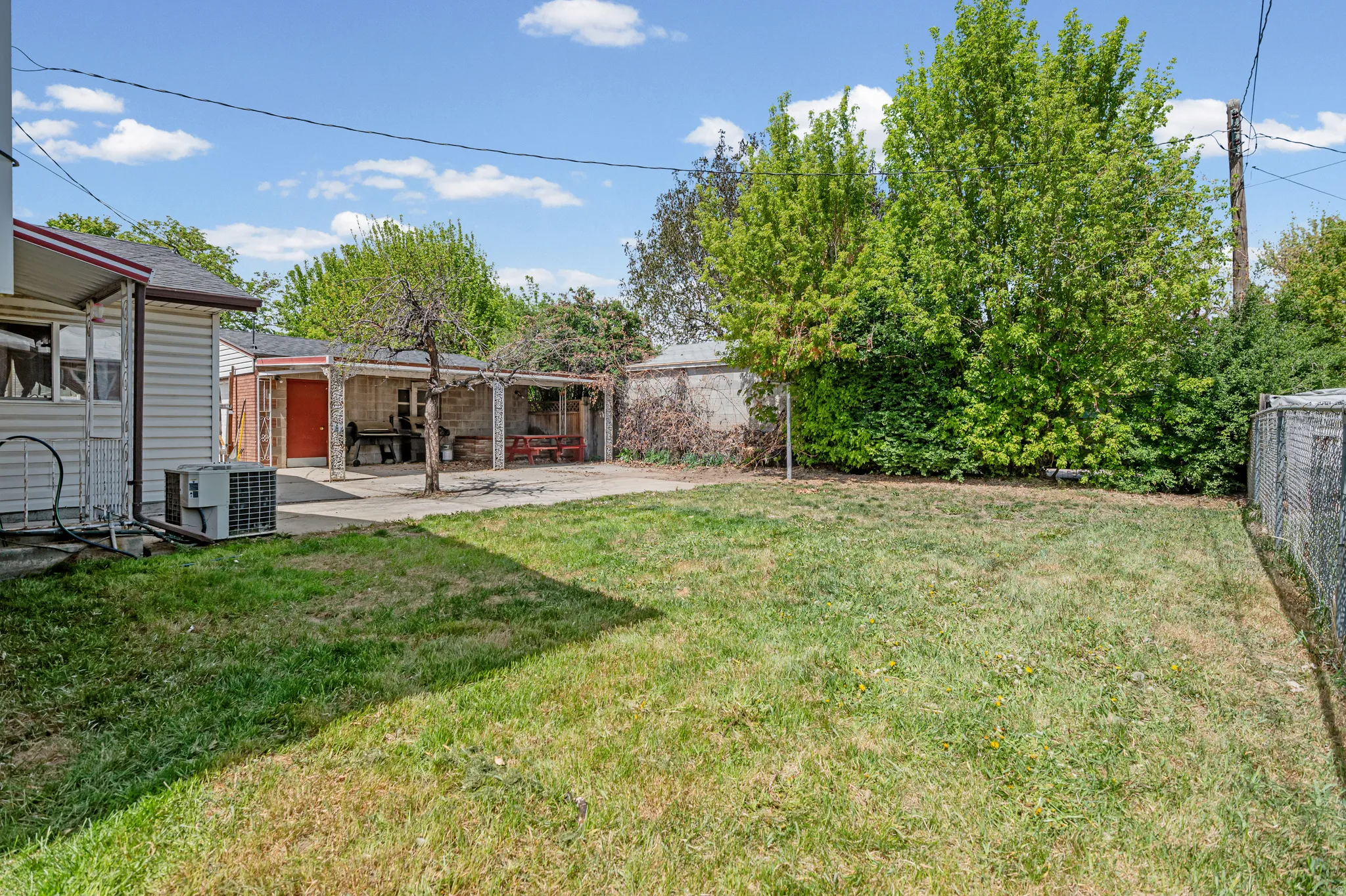 Fenced backyard with a patio area
