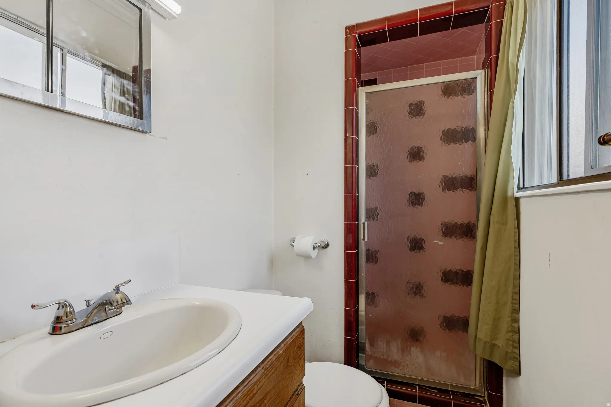 Bathroom featuring vanity and shower / tub combo with curtain
