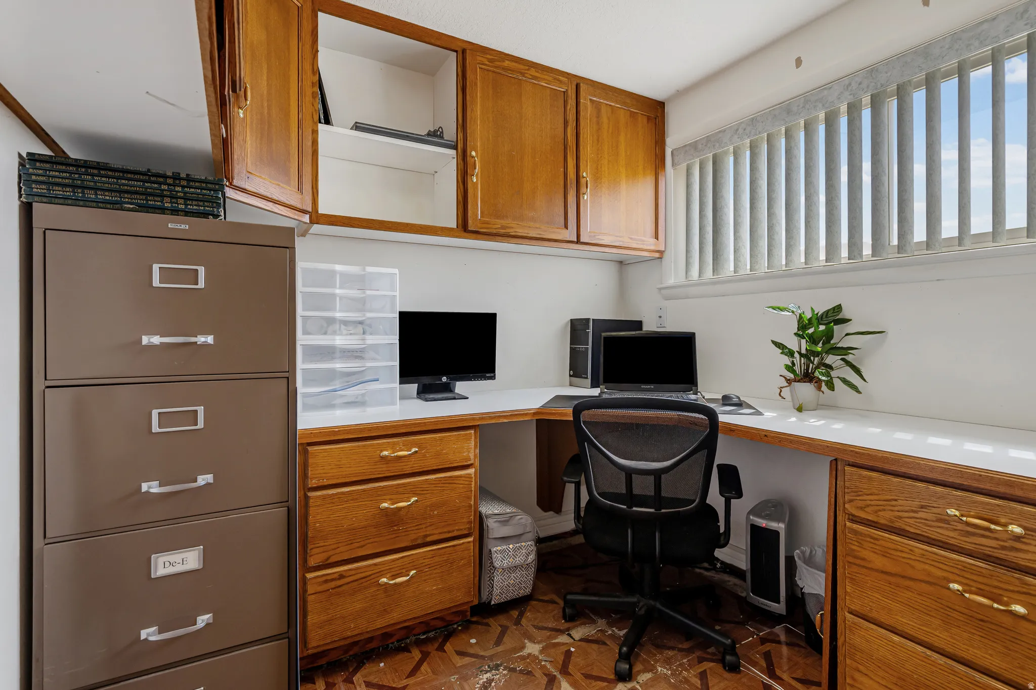 Office space featuring built in study area and parquet floors