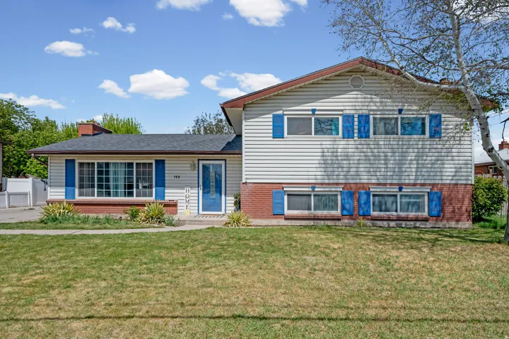 Tri-level home with a chimney and brick siding