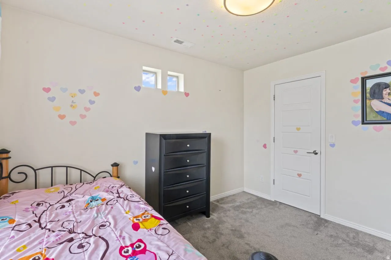 Bedroom featuring carpet flooring and baseboards