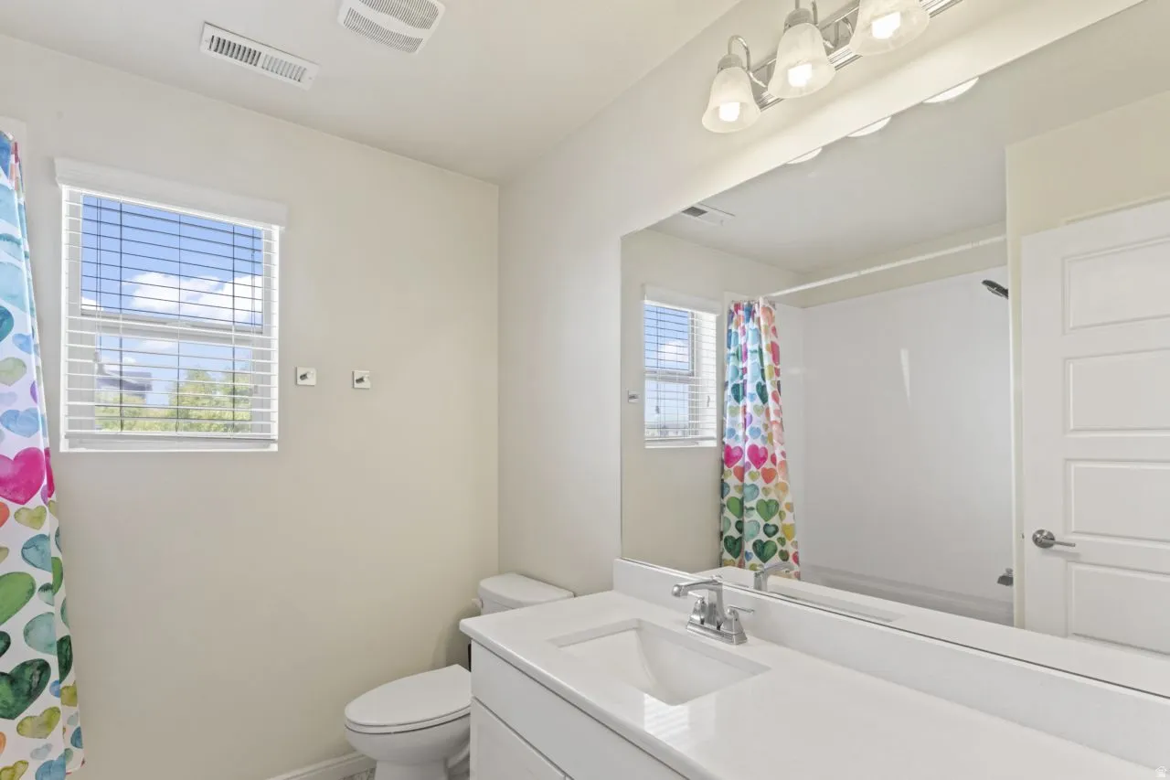 Bathroom featuring vanity and a shower with shower curtain