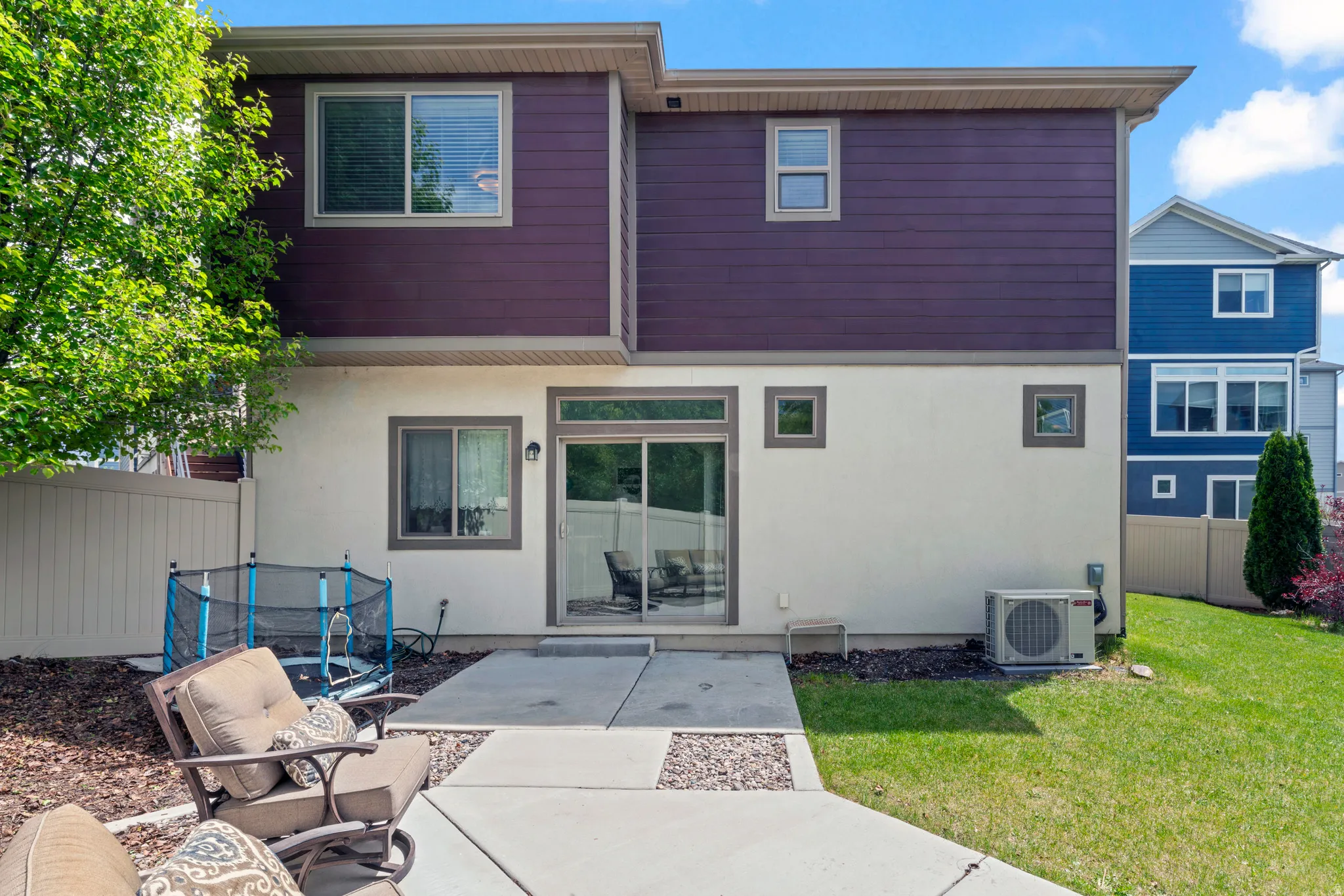 Rear exterior featuring two-story construction with ground-level stucco and upper-level horizontal siding