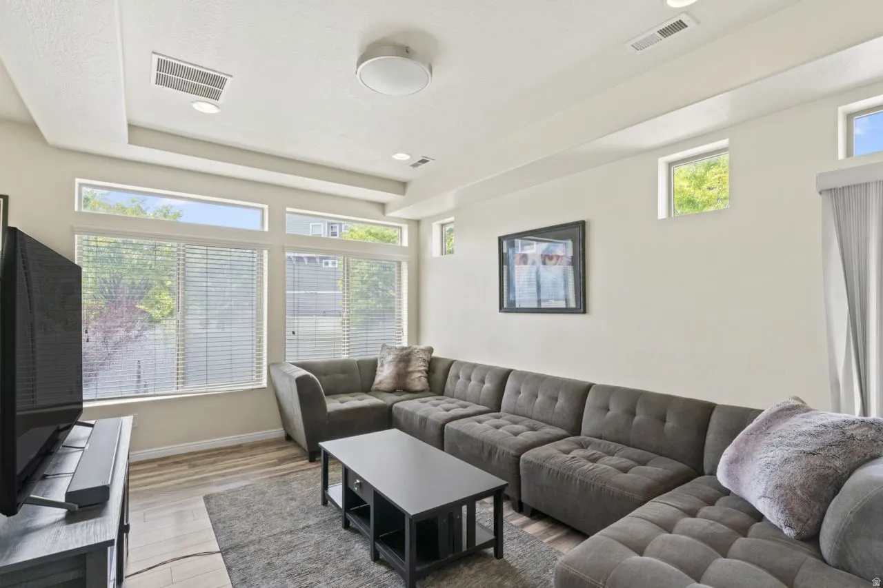 Living room featuring light wood-type flooring and recessed lighting