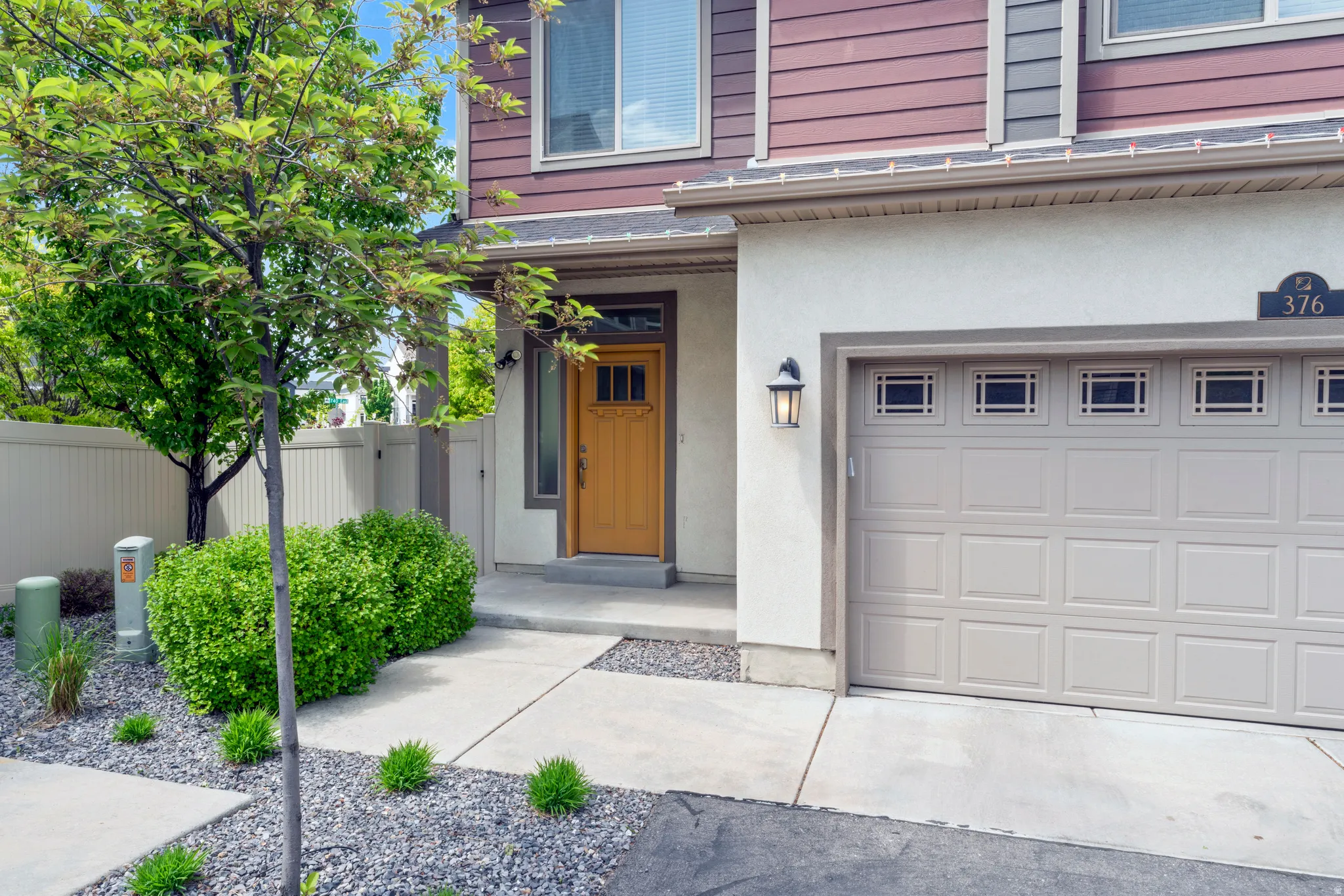 Brown siding exterior with a cream stucco finish