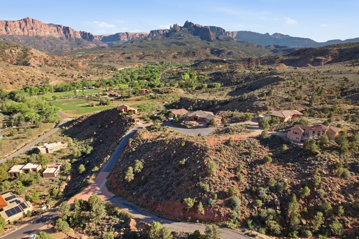 Aerial view of property and surrounding area with a mountain backdrop