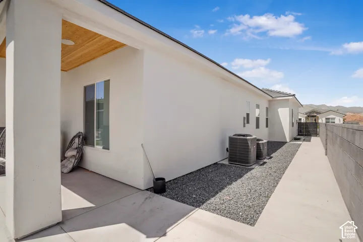 View of home's exterior featuring stucco siding and a cooling unit