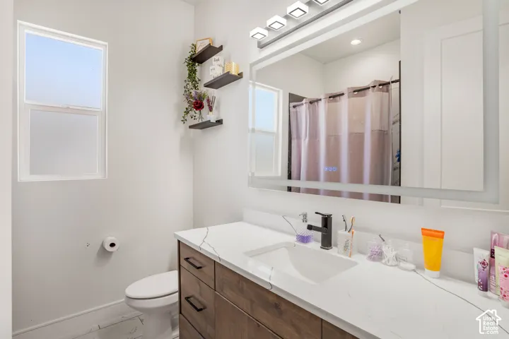 Bathroom with vanity and a shower with shower curtain