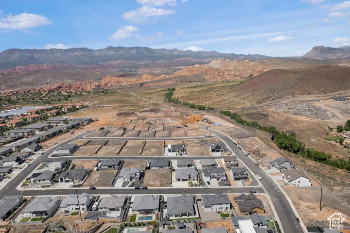 Aerial perspective of suburban area with a mountainous background
